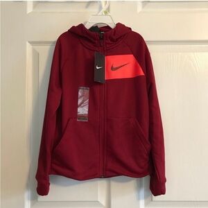 Red Nike hoodie and black and white shirt